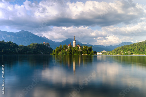 Wallpaper Mural Serene waters of Lake Bled reflect the idyllic church island and castle amidst the Julian Alps on a cloudy day Torontodigital.ca