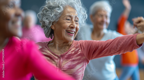 Smiling elderly women engaging in a fun dance workout session  enjoying rhythm and movement in a bright gym.