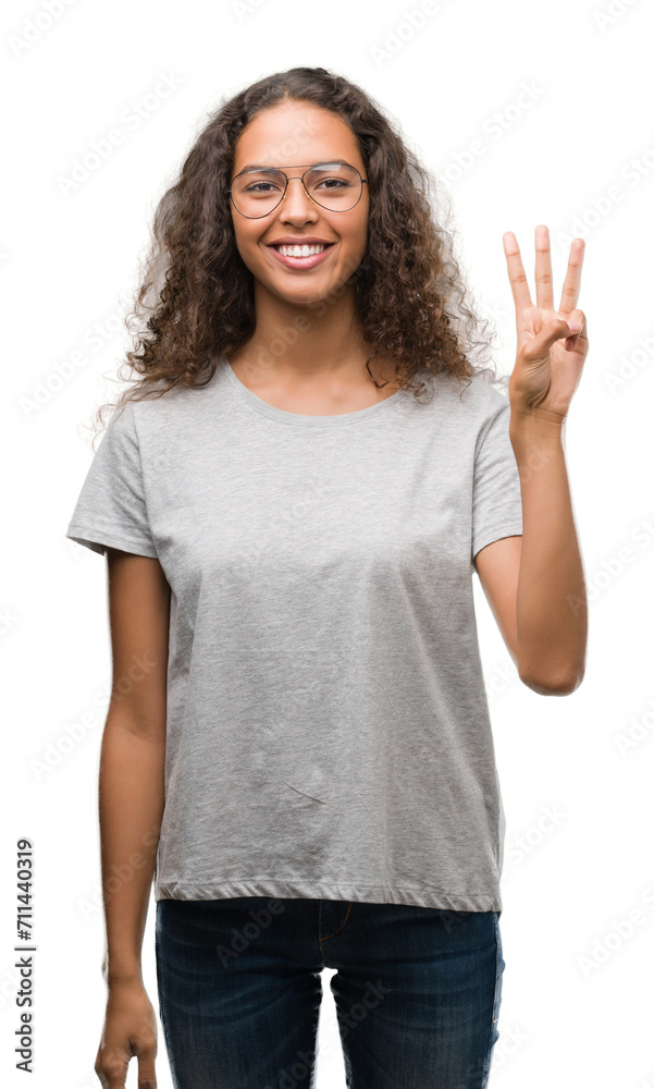 Beautiful young hispanic woman wearing glasses showing and pointing up with fingers number three while smiling confident and happy. Beautiful young hispanic woman wearing glasses showing and pointing up with fingers number three while smiling confident and happy.