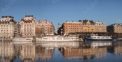 Hotel, steam commuter ferries and boats at the pier Strandvägen at the icy bay Nybroviken a part of the Ladugårdslandsviken a sunny winter day in Stockholm © Hans Baath