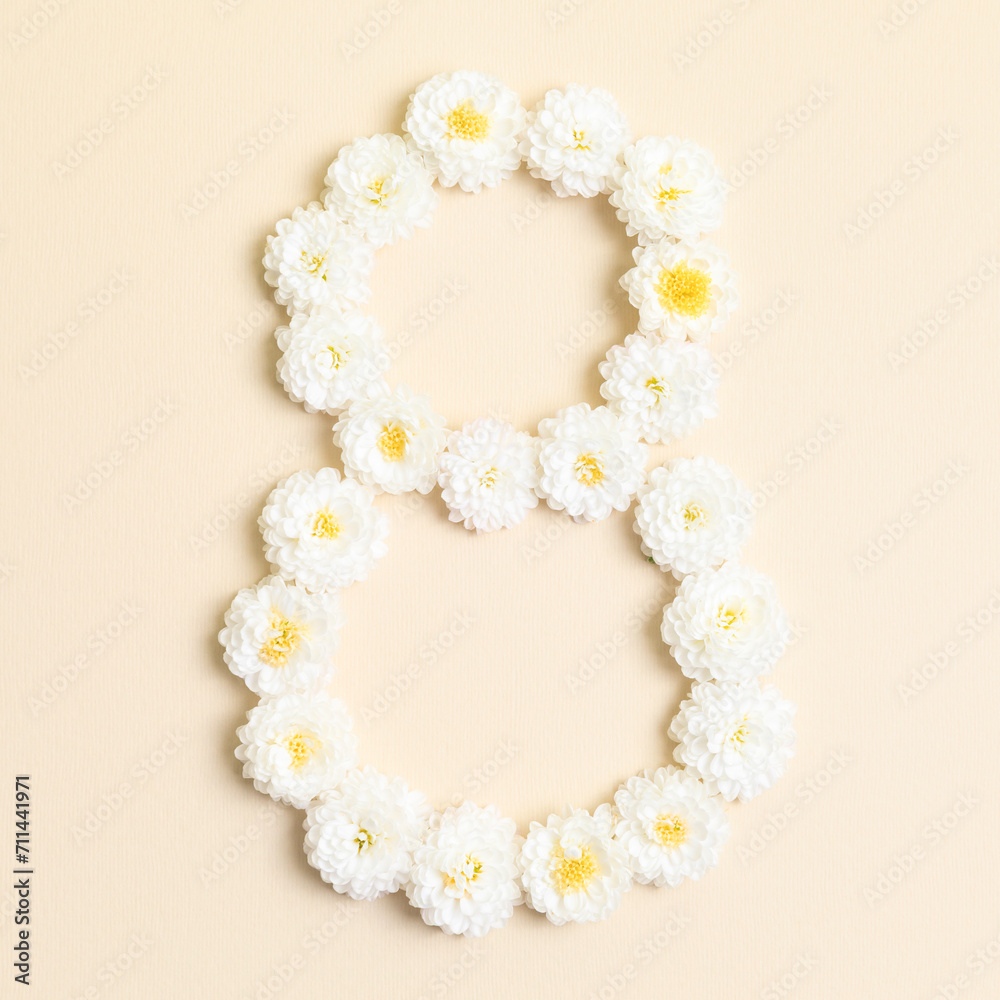 International Women's day, March 8th concept. Number eight 8 made of white chrysanthemum flowers on beige background. Flower font, shape. Creative spring idea, stylish trendy greeting card. Peach fuzz
