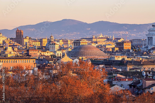 Roof top view of Rome historical center and the dome of Pantheon at golden hour. City skyline as seen from Castel Sant'Angelo. Rome, Italy photo