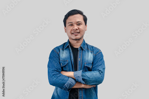Young Asian Man folded arms looking at camera with happy face expression on isolated background
