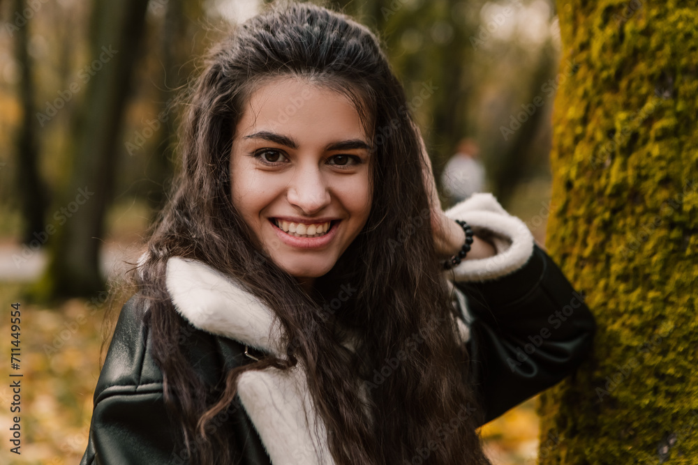 Attractive pretty woman walking outdoor, portrait of young lady in warm sunny autumn park season, fall, yellow orange red leaves, dressed leather wool fur jacket smiling having fun
Attractive pretty woman walking outdoor, portrait of young lady in warm sunny autumn park season, fall, yellow orange red leaves, dressed leather wool fur jacket smiling having fun