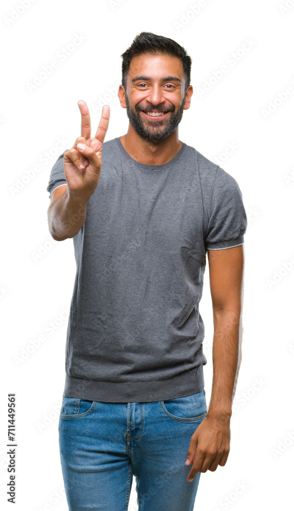 Adult hispanic man over isolated background smiling with happy face winking at the camera doing victory sign. Number two.