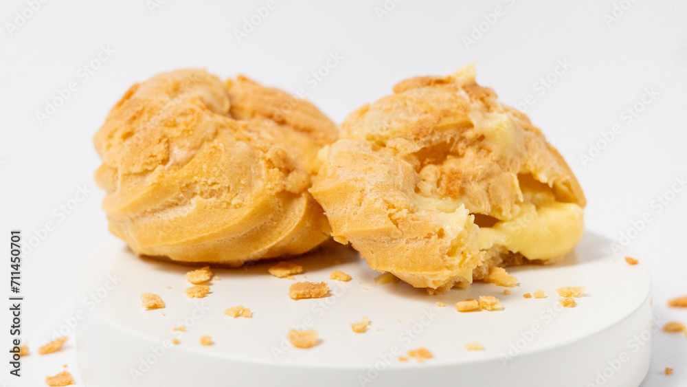 Freshly baked cream puffs or Vanilla eclairs isolated on white background Freshly baked cream puffs or Vanilla eclairs isolated on white background