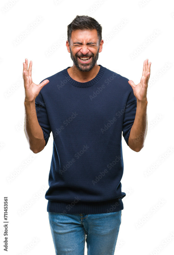 Adult hispanic man over isolated background celebrating mad and crazy for success with arms raised and closed eyes screaming excited. Winner concept Adult hispanic man over isolated background celebrating mad and crazy for success with arms raised and closed eyes screaming excited. Winner concept