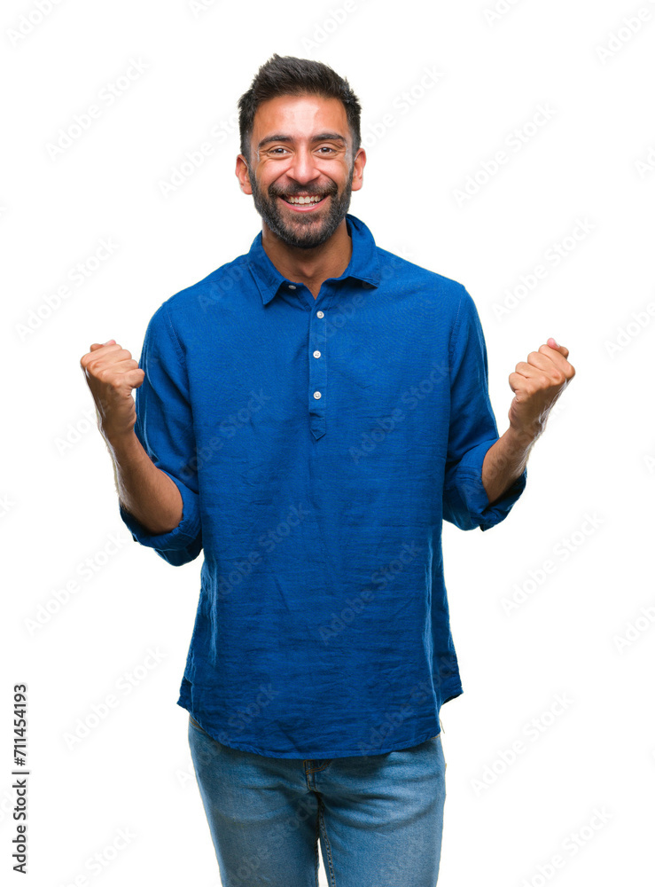 Adult hispanic man over isolated background celebrating surprised and amazed for success with arms raised and open eyes. Winner concept. Adult hispanic man over isolated background celebrating surprised and amazed for success with arms raised and open eyes. Winner concept.