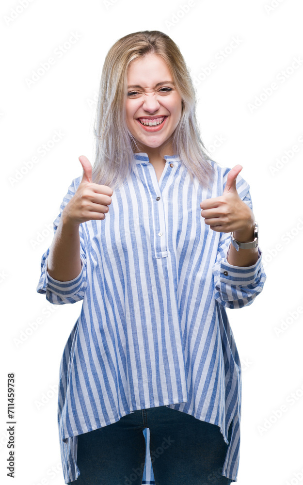 Young blonde woman over isolated background approving doing positive gesture with hand, thumbs up smiling and happy for success. Looking at the camera, winner gesture. Young blonde woman over isolated background approving doing positive gesture with hand, thumbs up smiling and happy for success. Looking at the camera, winner gesture.