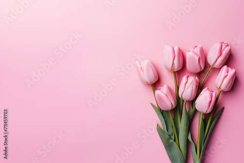 A bouquet of delicate pink tulips on a plain background.
