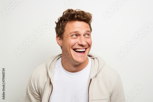 Portrait of a happy young man looking at camera over white background