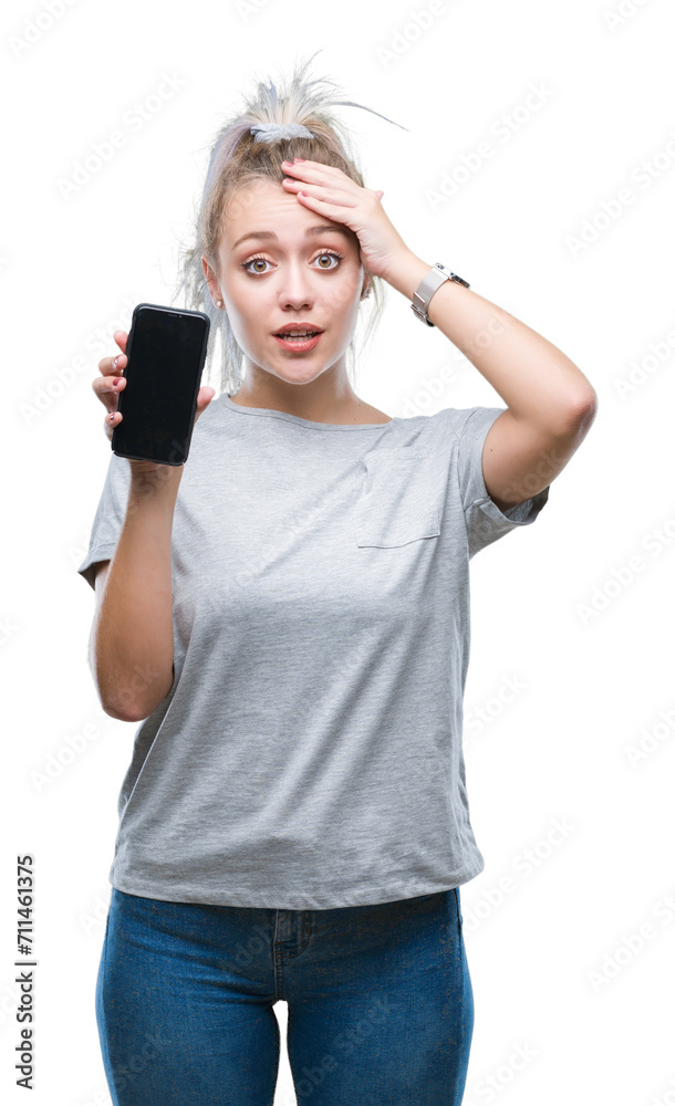 Young blonde woman showing screen of smartphone over isolated background stressed with hand on head, shocked with shame and surprise face, angry and frustrated. Fear and upset for mistake. Young blonde woman showing screen of smartphone over isolated background stressed with hand on head, shocked with shame and surprise face, angry and frustrated. Fear and upset for mistake.