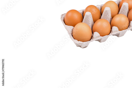 Many eggs lie on the background of hay, top view.