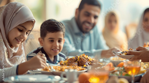 A family sharing an Iftar meal together  breaking their fast  Ramadan  blurred background  with copy space