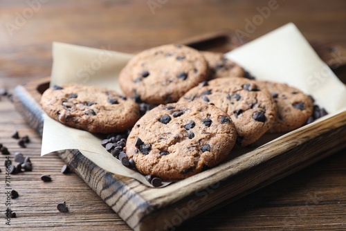 Delicious chocolate chip cookies on wooden table, closeup