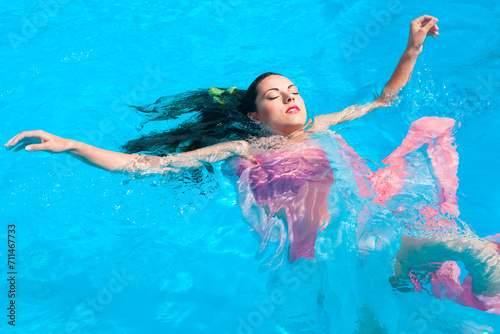 Portrait of a young beautiful woman in water