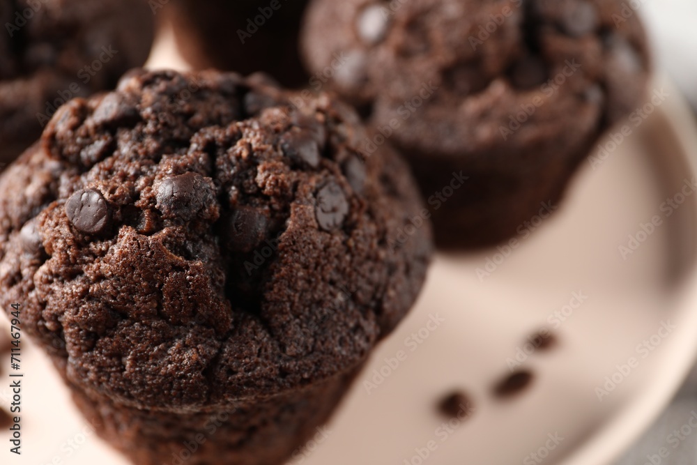 Fototapeta premium Delicious fresh chocolate muffins on table, closeup. Space for text