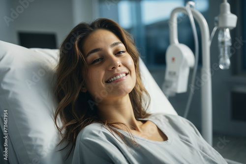 Generative AI image of a smiling woman lying in a hospital bed with an IV drip in the background, conveying a sense of recovery and optimism photo