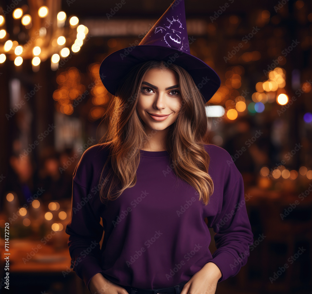Young Woman in Purple Sweatshirt with Witch Hat, Halloween Theme Young Woman in Purple Sweatshirt with Witch Hat, Halloween Theme