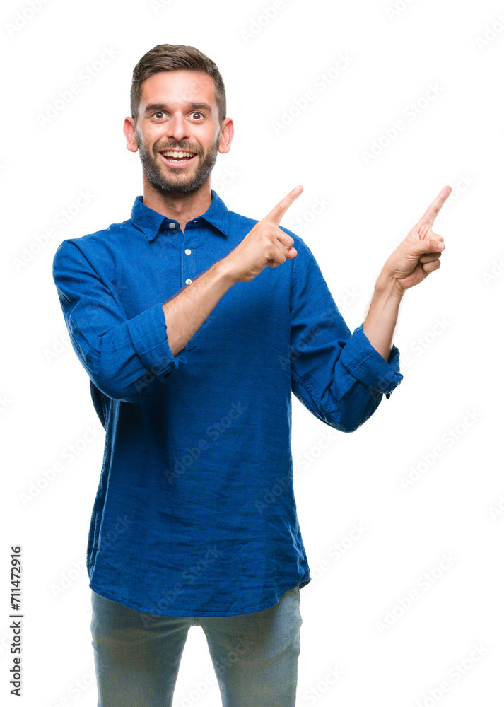 Young handsome man over isolated background smiling and looking at the camera pointing with two hands and fingers to the side. Young handsome man over isolated background smiling and looking at the camera pointing with two hands and fingers to the side.