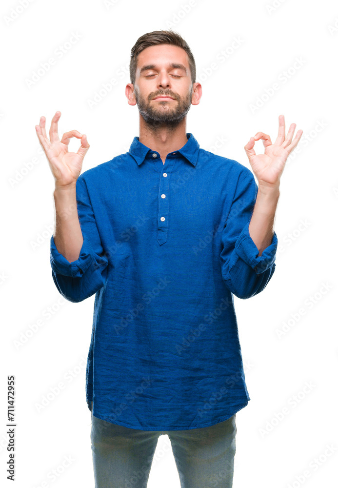 Young handsome man over isolated background relax and smiling with eyes closed doing meditation gesture with fingers. Yoga concept.