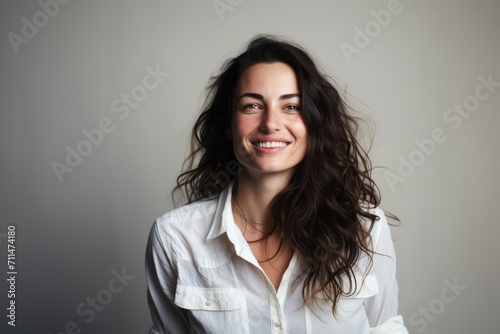 Portrait of a beautiful young brunette woman with long curly hair