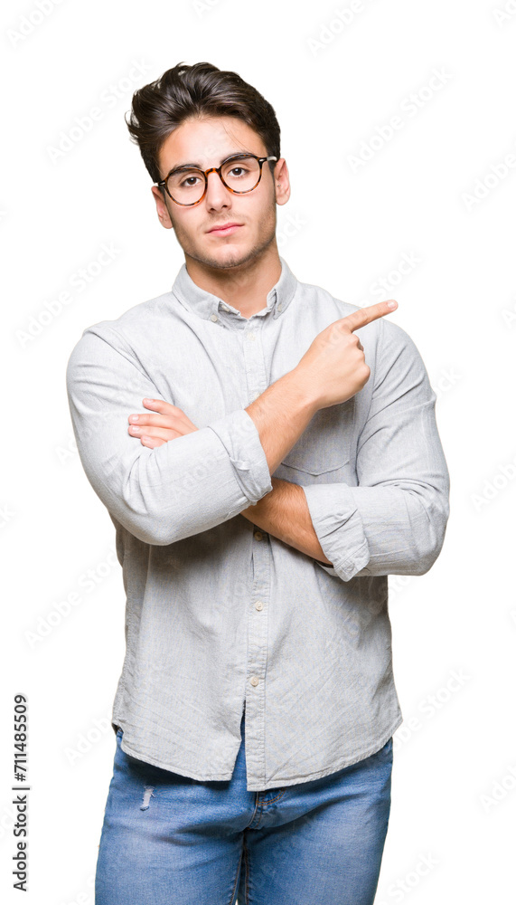 Young handsome man wearing glasses over isolated background Pointing with hand finger to the side showing advertisement, serious and calm face Young handsome man wearing glasses over isolated background Pointing with hand finger to the side showing advertisement, serious and calm face