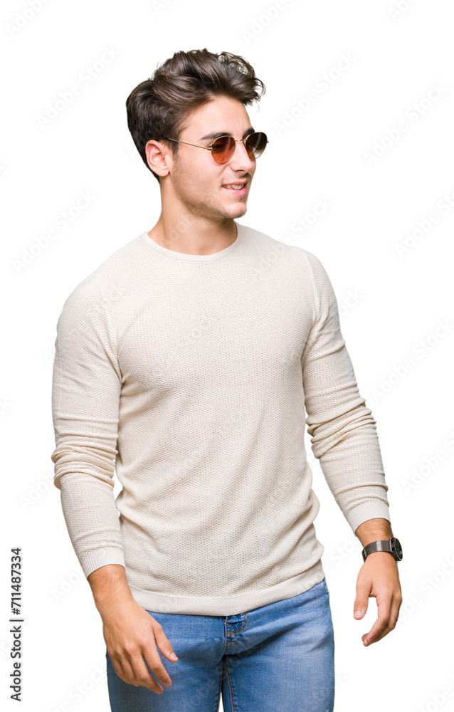 Young handsome man wearing sunglasses over isolated background looking away to side with smile on face, natural expression. Laughing confident. Young handsome man wearing sunglasses over isolated background looking away to side with smile on face, natural expression. Laughing confident.