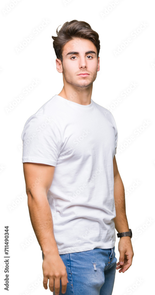 Young handsome man wearing white t-shirt over isolated background with serious expression on face. Simple and natural looking at the camera. Young handsome man wearing white t-shirt over isolated background with serious expression on face. Simple and natural looking at the camera.