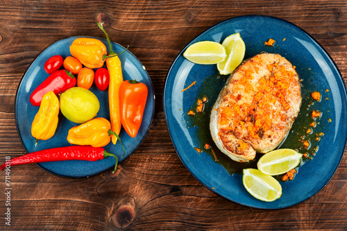 Fried salmon steak on wooden table