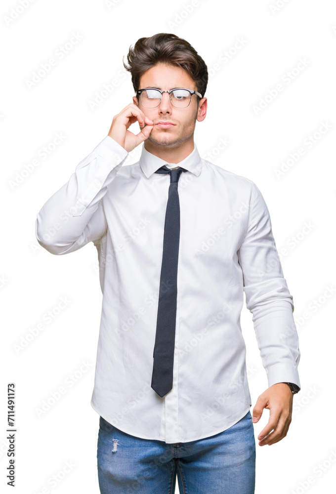Young business man wearing glasses over isolated background mouth and lips shut as zip with fingers. Secret and silent, taboo talking Young business man wearing glasses over isolated background mouth and lips shut as zip with fingers. Secret and silent, taboo talking