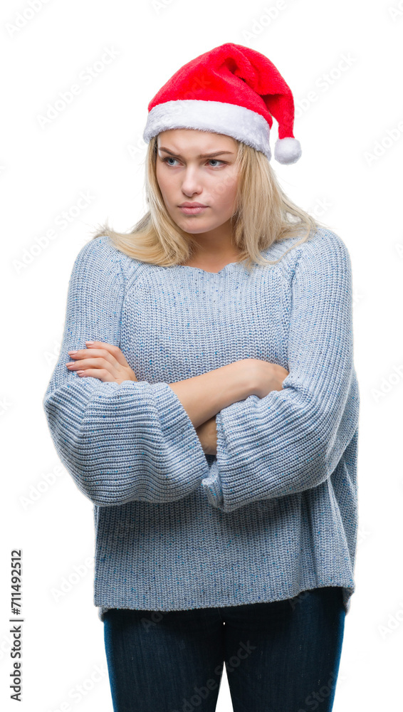 Young caucasian woman wearing christmas hat over isolated background skeptic and nervous, disapproving expression on face with crossed arms. Negative person.