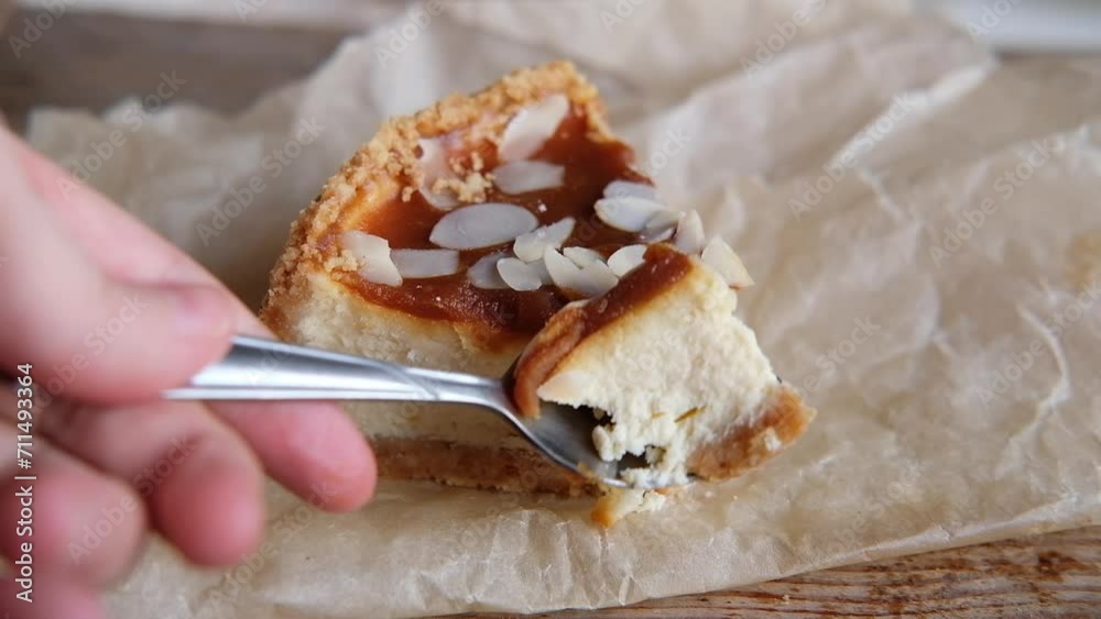 cut with a spoon a piece of caramel cheesecake on a wooden background, top view. New york cheesecake, copy space cut with a spoon a piece of caramel cheesecake on a wooden background, top view. New york cheesecake, copy space