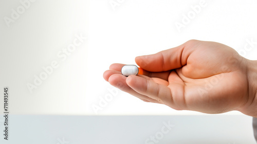 Pills in hand on a light background