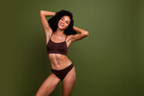 Studio no retouch photo of positive funky lady dressed lingerie accepting imperfections empty space isolated green color background