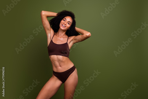 Studio no retouch photo of positive funky lady dressed lingerie accepting imperfections empty space isolated green color background