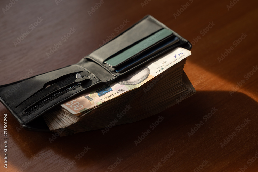 Mans wallet full of Ukrainian hryvnia money. Stack of 500 hryvnia banknotes in wallet Mans wallet full of Ukrainian hryvnia money. Stack of 500 hryvnia banknotes in wallet