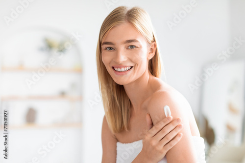 blonde lady in white towel applies moisturizer on shoulder indoor Free Download blonde lady in white towel applies moisturizer on shoulder indoor - GFXLoad