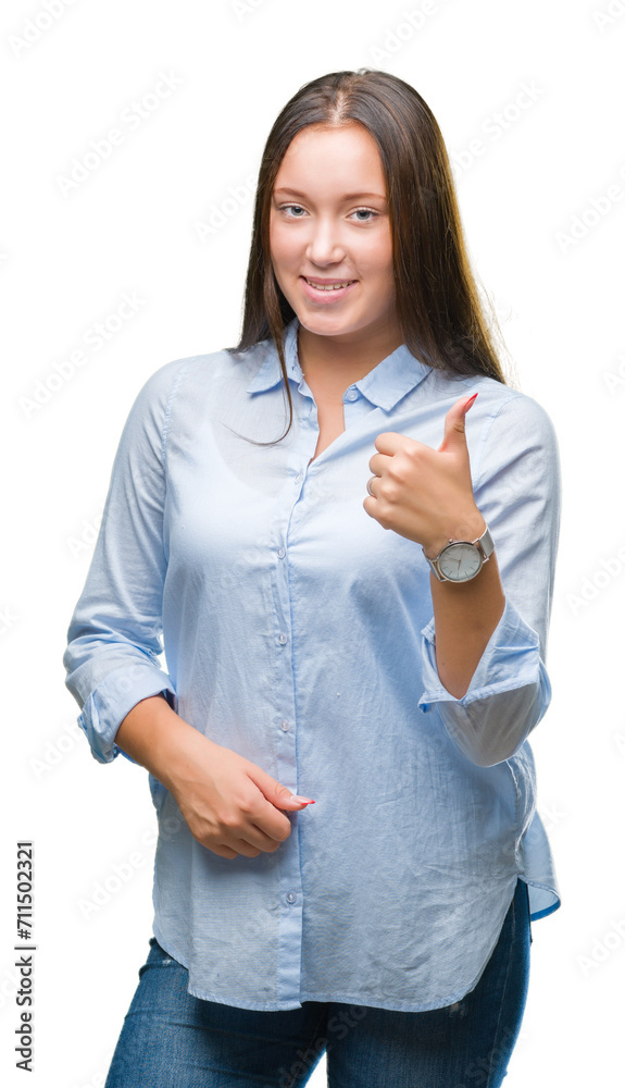 Young caucasian beautiful woman over isolated background doing happy thumbs up gesture with hand. Approving expression looking at the camera with showing success. Young caucasian beautiful woman over isolated background doing happy thumbs up gesture with hand. Approving expression looking at the camera with showing success.