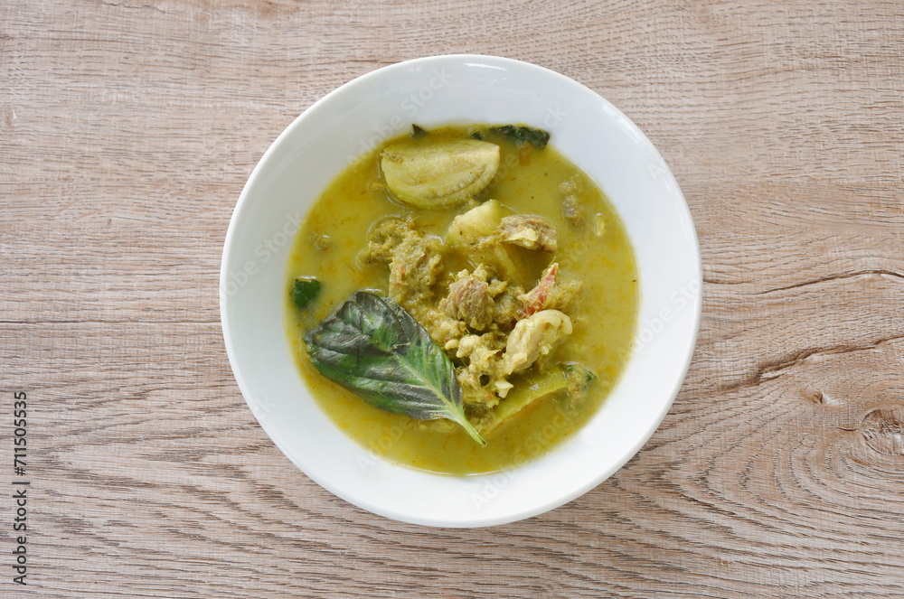 spicy boiled slice beef meat with eggplant in coconut milk green curry soup on bowl spicy boiled slice beef meat with eggplant in coconut milk green curry soup on bowl