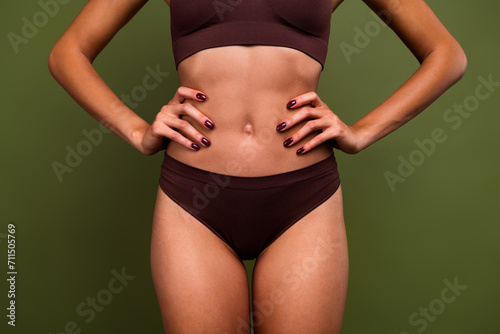 Cropped no filter photo of slender thin sporty girl abdominal abs gym exercises training isolated on khaki color background © deagreez