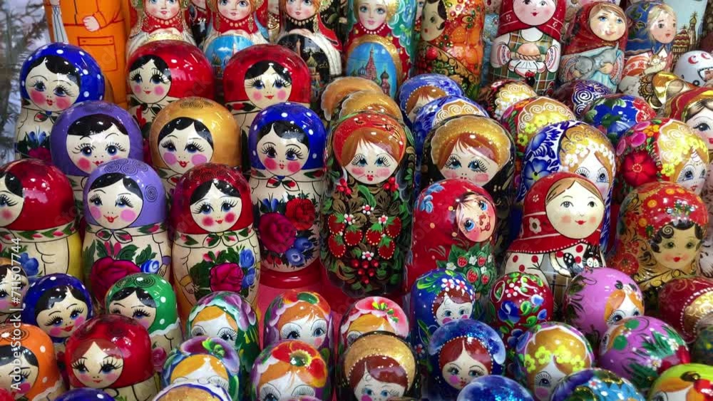 Many colorful Russian wooden souvenirs (matrioshka, nesting dolls) on the counter at a christmas fair.