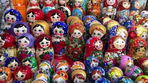 Many colorful Russian wooden souvenirs (matrioshka, nesting dolls) on the counter at a christmas fair. photo