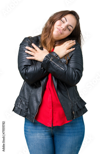 Beautiful plus size young woman wearing a fashion leather jacket over isolated background Hugging oneself happy and positive, smiling confident. Self love and self care