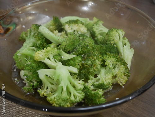 Steamed broccoli florets on a plate, close-up view.