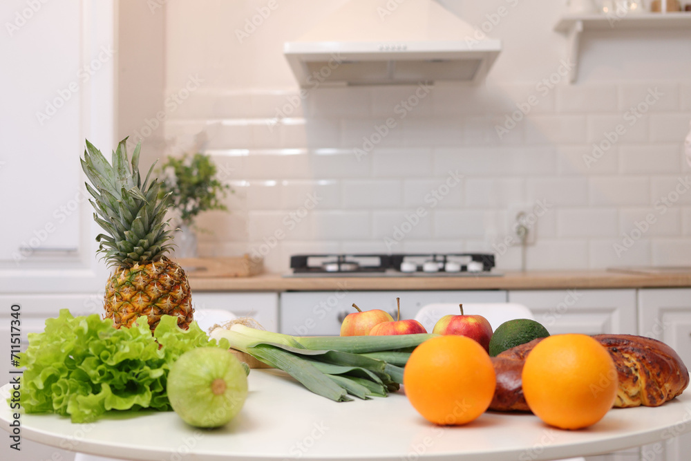 Beautiful kitchen interior design features white table adorned with group of fresh fruits and vegetables creating refreshing and healthy atmosphere with organic meals Beautiful kitchen interior design features white table adorned with group of fresh fruits and vegetables creating refreshing and healthy atmosphere with organic meals