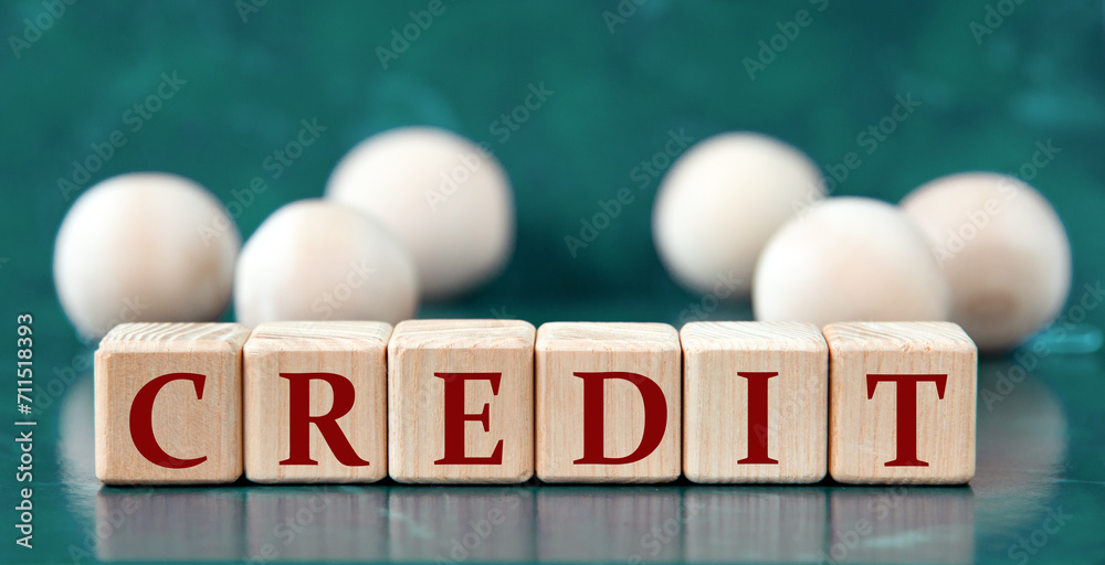 CREDIT - word on wooden cubes on a green background with wooden balls CREDIT - word on wooden cubes on a green background with wooden balls