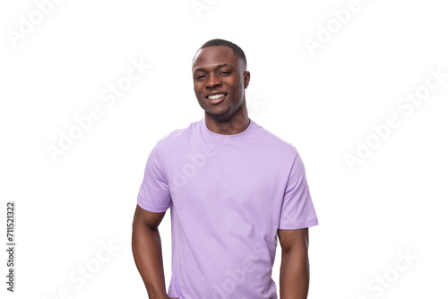 young successful american man dressed in a light lilac t-shirt on a white background with copy space