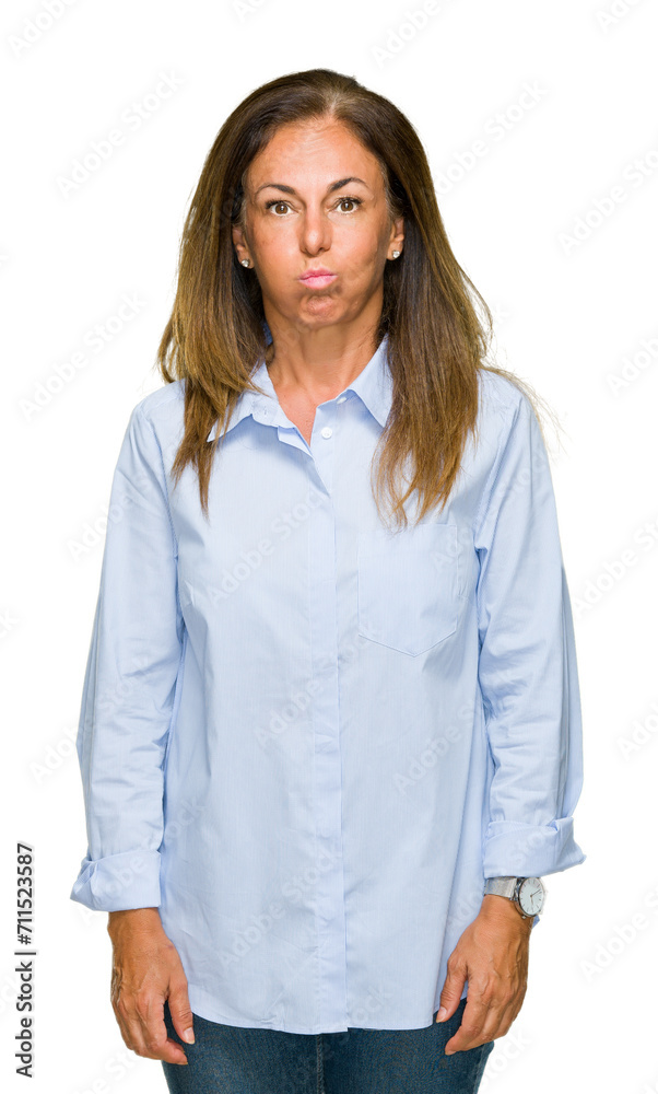 Beautiful middle age business adult woman over isolated background puffing cheeks with funny face. Mouth inflated with air, crazy expression. Beautiful middle age business adult woman over isolated background puffing cheeks with funny face. Mouth inflated with air, crazy expression.