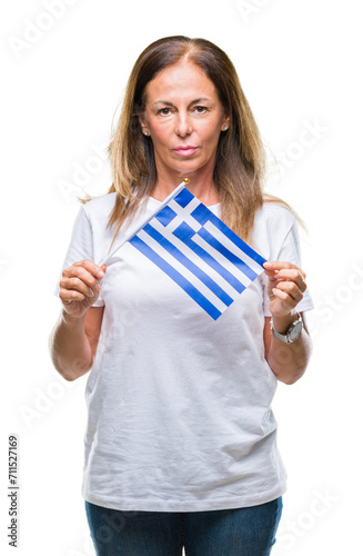 Middle age hispanic woman holding flag of Greece over isolated background with a confident expression on smart face thinking serious